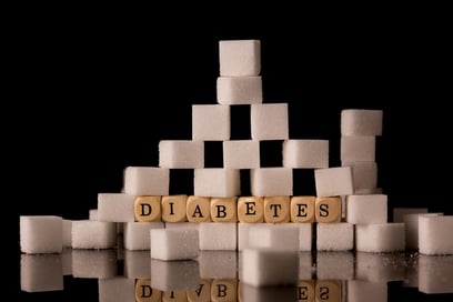 Sugar cubes stacked on black background